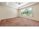 Bright bedroom with carpet floors and large window at 1748 Golfview Dr, Kissimmee, FL 34746
