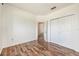 Bedroom with wood-look flooring and large closet at 1748 Golfview Dr, Kissimmee, FL 34746