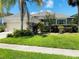 House exterior with a two-car garage and landscaped yard at 1748 Golfview Dr, Kissimmee, FL 34746
