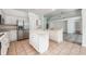 Kitchen with island, stainless steel appliances, and white cabinets at 1748 Golfview Dr, Kissimmee, FL 34746