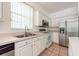 Kitchen with stainless steel appliances and white cabinets at 1748 Golfview Dr, Kissimmee, FL 34746