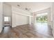 Large living room featuring tile floors and access to backyard at 1748 Golfview Dr, Kissimmee, FL 34746