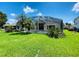 Backyard view of a home with a large pool and fenced area at 1748 Golfview Dr, Kissimmee, FL 34746