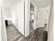 Bright hallway with doors to bedrooms and updated flooring at 1918 Conway Rd # 3, Orlando, FL 32812