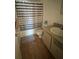 Bathroom with tub shower, vanity, and striped shower curtain at 2761 L B Mcleod Rd # C, Orlando, FL 32805