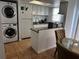 Kitchen with white cabinets, granite countertops, and a stackable washer/dryer at 2761 L B Mcleod Rd # C, Orlando, FL 32805