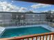 Community pool with surrounding patio furniture and building in background at 2761 L B Mcleod Rd # C, Orlando, FL 32805