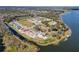 Aerial view of homes and community by the lake at 3019 Tackle Dr, Leesburg, FL 34748