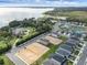 Aerial view of a lakefront community with houses and new construction at 3019 Tackle Dr, Leesburg, FL 34748