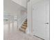 Bright entryway with tile flooring, staircase, and access to the living areas at 3019 Tackle Dr, Leesburg, FL 34748