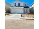 Two-story home with white exterior and a two-car garage at 3019 Tackle Dr, Leesburg, FL 34748
