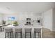 Modern kitchen with white cabinets, island, and marble countertops at 3019 Tackle Dr, Leesburg, FL 34748