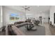 Spacious living room with a view to the backyard, staged furniture, and large windows at 3019 Tackle Dr, Leesburg, FL 34748