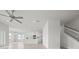 Open living room and kitchen area with tile floors and ceiling fan at 3019 Tackle Dr, Leesburg, FL 34748