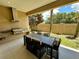Outdoor kitchen and dining area with a spacious backyard at 3185 Brasilia Ave, Kissimmee, FL 34747