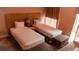 Bedroom with two twin beds, nightstand, and large window at 3185 Brasilia Ave, Kissimmee, FL 34747