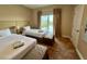 Guest bedroom with two twin beds and balcony access at 3185 Brasilia Ave, Kissimmee, FL 34747