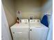 Laundry closet with washer, dryer, and ironing board at 3185 Brasilia Ave, Kissimmee, FL 34747