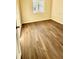 Spacious bedroom with wood-look flooring and large window at 322 N 6Th St, Haines City, FL 33844