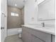 Modern bathroom with gray tile and updated vanity at 6264 Sw 144Th Pl, Ocala, FL 34473