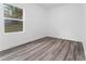 Simple bedroom with wood-look floors and a window at 6264 Sw 144Th Pl, Ocala, FL 34473