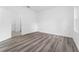 Well-lit bedroom with wood-look floors and access to bathroom at 6264 Sw 144Th Pl, Ocala, FL 34473