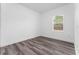 Simple bedroom with wood-look flooring and window at 6264 Sw 144Th Pl, Ocala, FL 34473