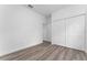 Spacious bedroom featuring wood-look floors and large closet at 6264 Sw 144Th Pl, Ocala, FL 34473