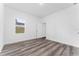 Spacious bedroom with wood-look floors and window at 6264 Sw 144Th Pl, Ocala, FL 34473