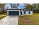 One-story house with gray garage door and white exterior at 6264 Sw 144Th Pl, Ocala, FL 34473