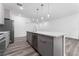 Modern kitchen with island, stainless steel appliances, and gray cabinets at 6264 Sw 144Th Pl, Ocala, FL 34473