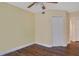 Bedroom with wood floors, double-door closet, and ceiling fan at 814 Crest Pines Dr # 928, Orlando, FL 32828