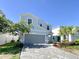 Two-story house with gray siding, gray garage door, and a paved driveway at 8956 Zurich Ln, Kissimmee, FL 34747