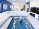 Spacious living room with white sectional sofa and blue accents at 8956 Zurich Ln, Kissimmee, FL 34747