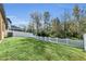 Fenced backyard with grassy area and white picket fence at 10184 Moss Rose Way, Orlando, FL 32832