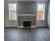 Living room with modern fireplace and gray floors at 1174 Bryn Mawr Dr, Daytona Beach, FL 32114