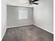 Bright bedroom featuring gray carpeting and a ceiling fan at 152 Springwood Cir # B, Longwood, FL 32750