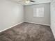Well-lit bedroom with gray carpeting and ceiling fan at 152 Springwood Cir # B, Longwood, FL 32750