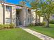 Exterior view of condo building with manicured lawn and walkway at 152 Springwood Cir # B, Longwood, FL 32750