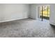 Spacious living room with gray carpet and sliding glass doors at 152 Springwood Cir # B, Longwood, FL 32750