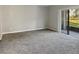 Spacious living room with gray carpeting and sliding glass doors at 152 Springwood Cir # B, Longwood, FL 32750