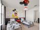 Mickey Mouse themed bedroom with twin beds and playful decor at 1627 Kona Ln, Davenport, FL 33897