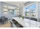 Modern dining room with a large white table and gray chairs at 1627 Kona Ln, Davenport, FL 33897
