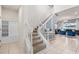 Two-story entryway with staircase and built-in shelving at 1627 Kona Ln, Davenport, FL 33897