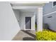 Gray front door with a covered entryway and brick pavers at 1627 Kona Ln, Davenport, FL 33897