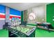 Basement game room with foosball, air hockey, and a sports theme at 1627 Kona Ln, Davenport, FL 33897