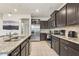 Modern kitchen with granite countertops and stainless steel appliances at 1627 Kona Ln, Davenport, FL 33897