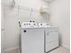 Bright laundry room, washer, dryer, and shelving at 1627 Kona Ln, Davenport, FL 33897