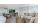 Bright and airy living room featuring comfy seating and large TV at 218 Amberwood Way, Umatilla, FL 32784