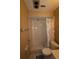 Bathroom with a shower/tub combo, tiled walls and floor, and a seashell shower curtain at 2214 Winnetka Ct, Orlando, FL 32818